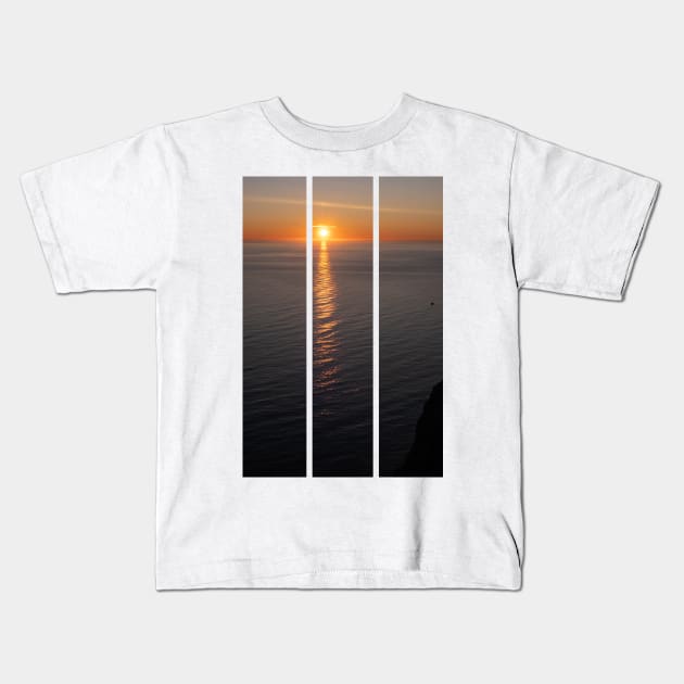 Wonderful landscapes in Norway. Nord-Norge. Beautiful scenery of a midnight sun sunset at Nordkapp (Cape North). Boat and globe on a cliff. Rippled sea and clear orange sky. (vertical) Kids T-Shirt by fabbroni-art